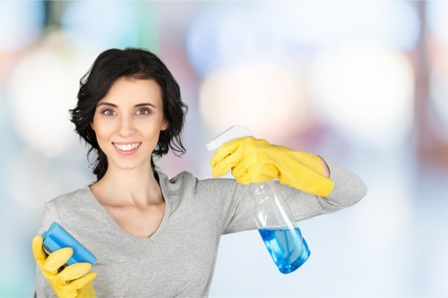 Cleaner using PPE while completing a safety-conscious cleaning task